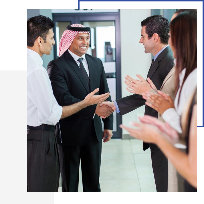 A group of people standing around talking to each other.